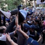 With hip-hop and f-bombs, Andrew Yang rallies the faithful at MacArthur Park